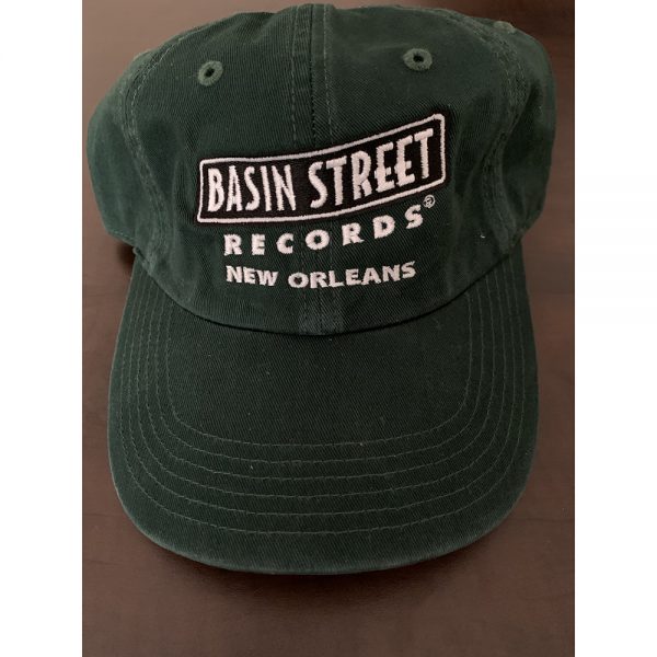 Adjustable golf/dad hat style hat in dark green color with the Basin Street Records logo embroidered on front in black